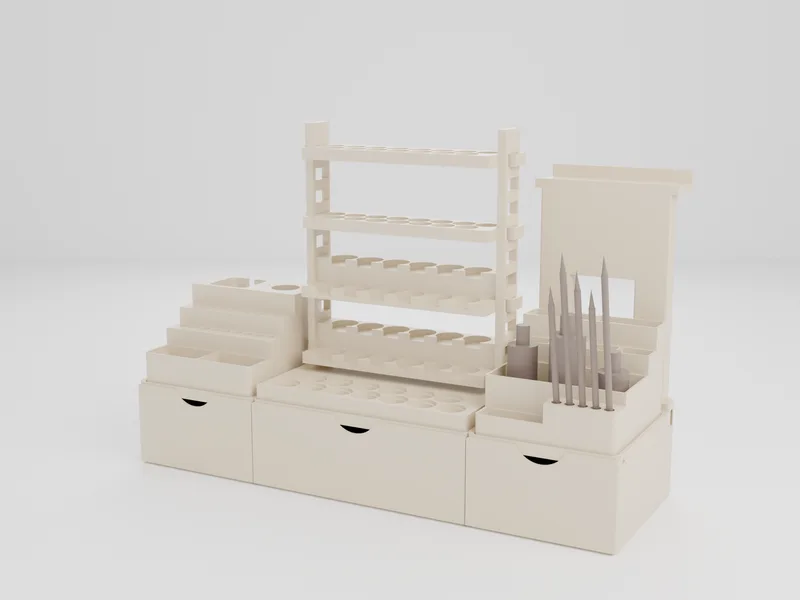 Design render of a three-section workstation base: a Rotary Tool Station, a Paint Rack Gallery Ladder standing as its own tower, and a bin module with brushes at the front, each in a shaped pocket on one run of drawers, with a display frame behind the bin module