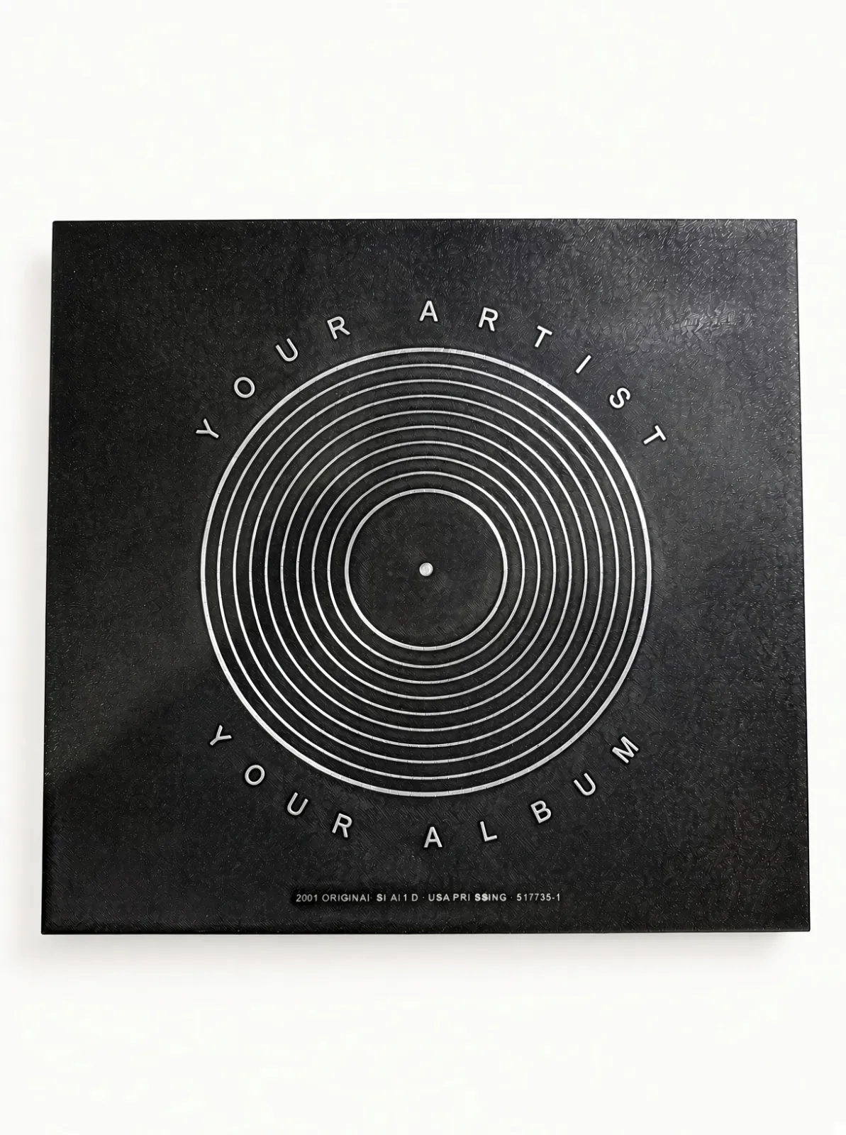 Engraved vinyl record box we printed, closed, showing the silver artist and album arcs around the vinyl-groove motif