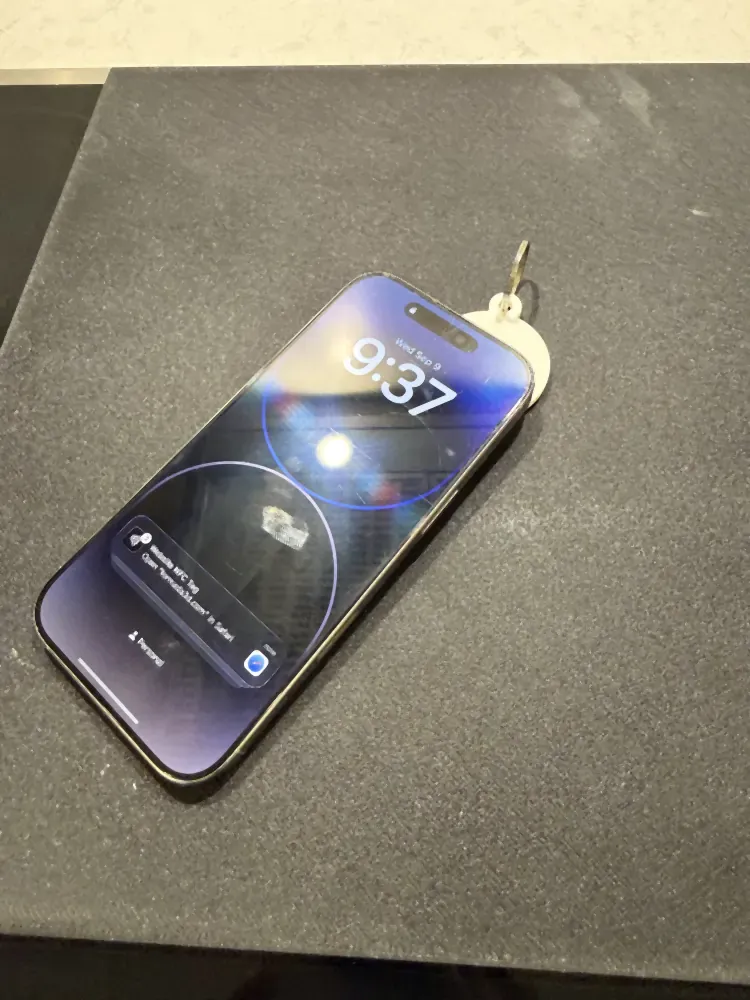 iPhone lock screen showing the Website NFC Tag notification after tapping a printed round tag